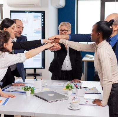 Cheerful overjoyed business people in conference room celerating Diverse colleagues with new opportunity enjoing victory meeting in broadroom office.